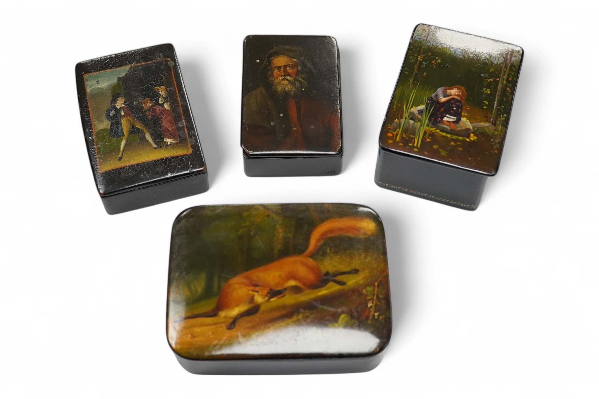 Four late 19th/early 20th century Russian lacquer boxes, largest 10.5cm. Condition - fair to good